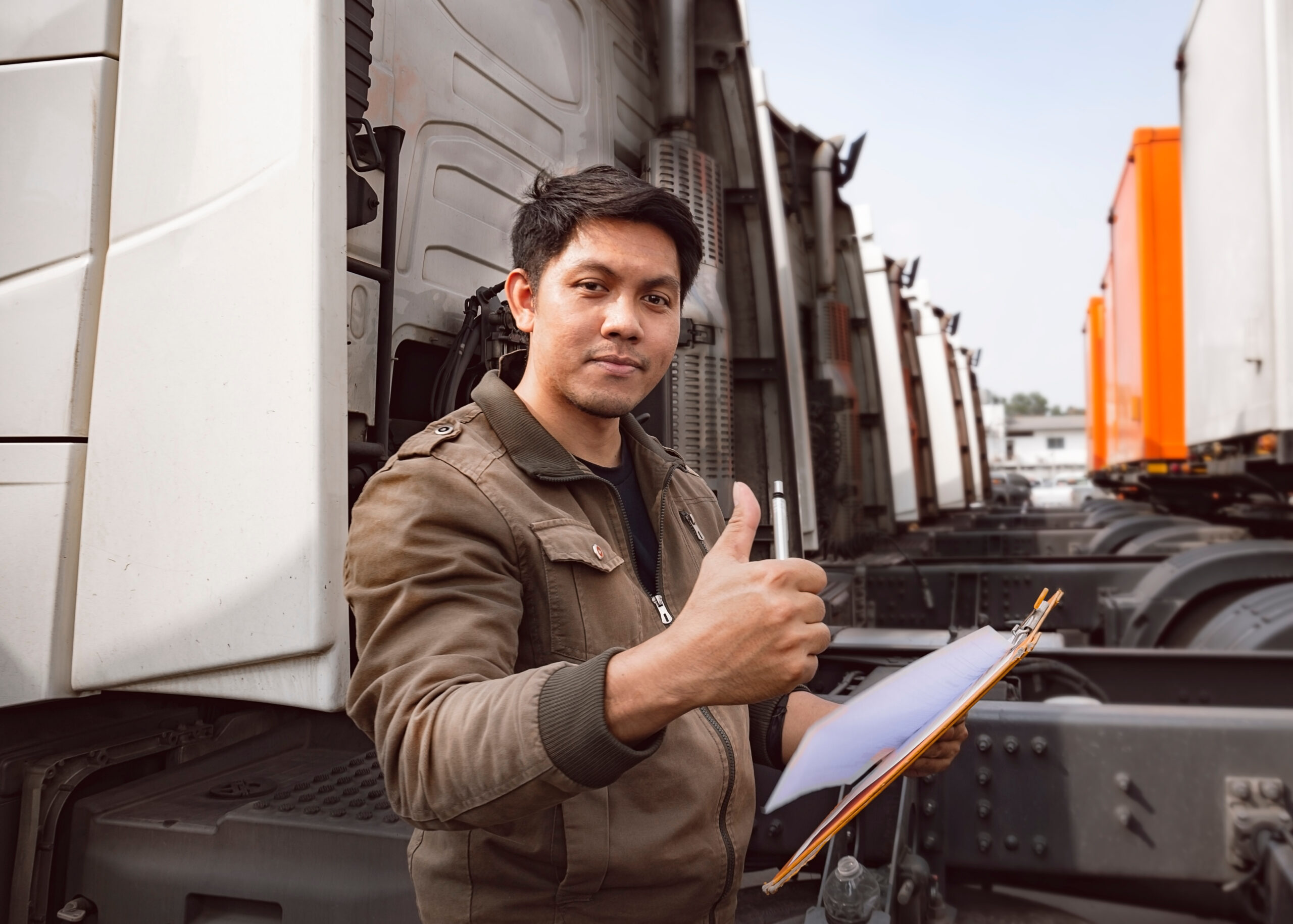 Portrait of truck driver happy smile with giving thumb-up, inspection safety vehicle maintenance checklist of a semi truck.